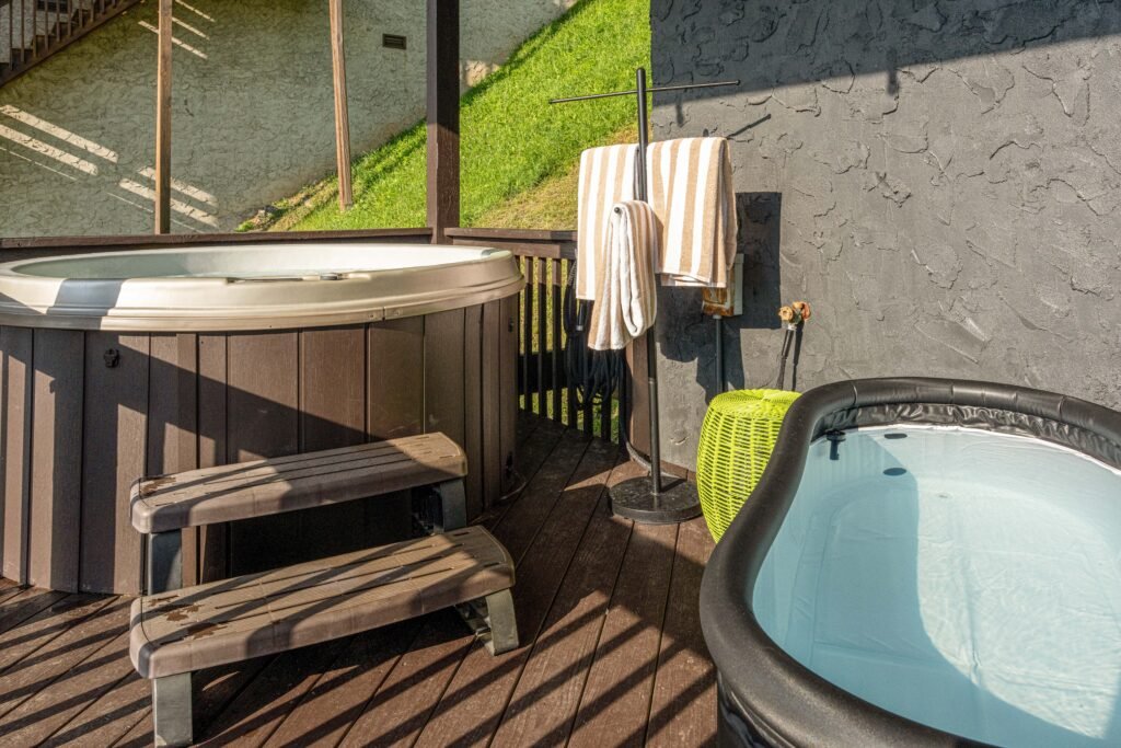 Outdoor hot tub and towels on the deck at Wolf and Wander in Mars Hill, North Carolina