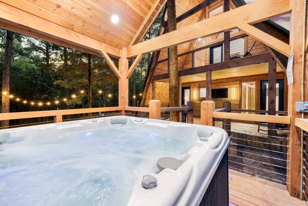 Hot tub and A-frame deck lit at dusk at Tahoe in the Pines