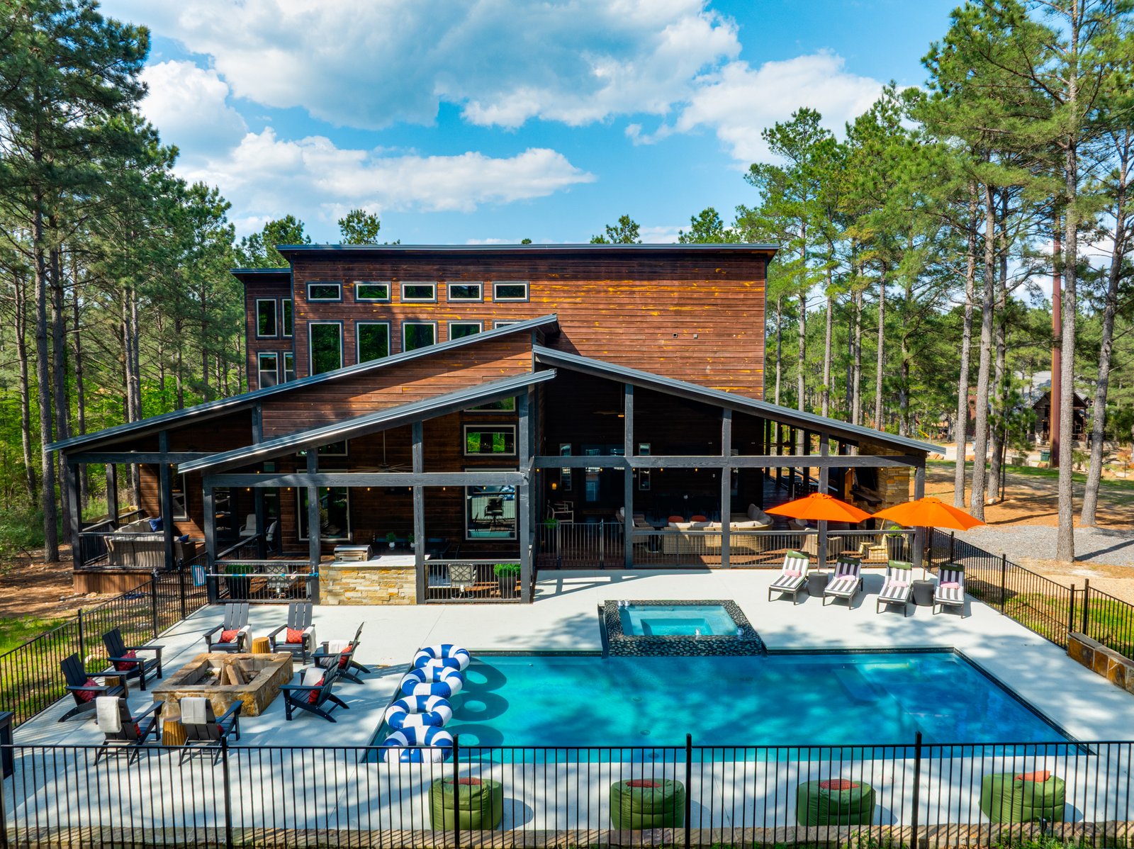 Broken Bow cabins with pool and luxury outdoor seating area in daylight