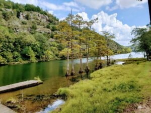 Broken Bow Lake swimming hole near Broken Bow OK with clear green water and cypress trees